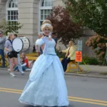 Cinderella waves to kids along the parade route Sunday.